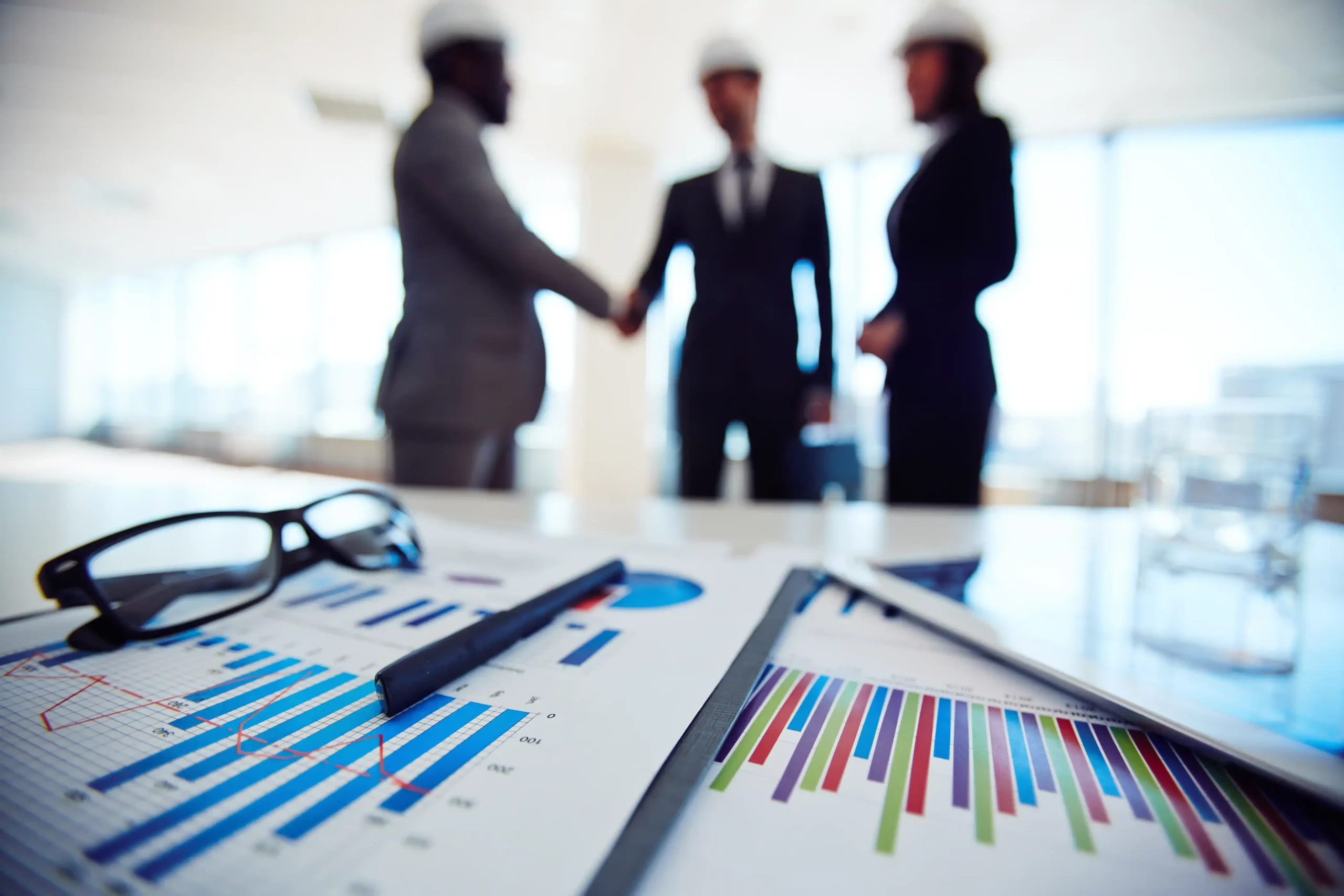 Business objects with executives discussing blueprint meeting