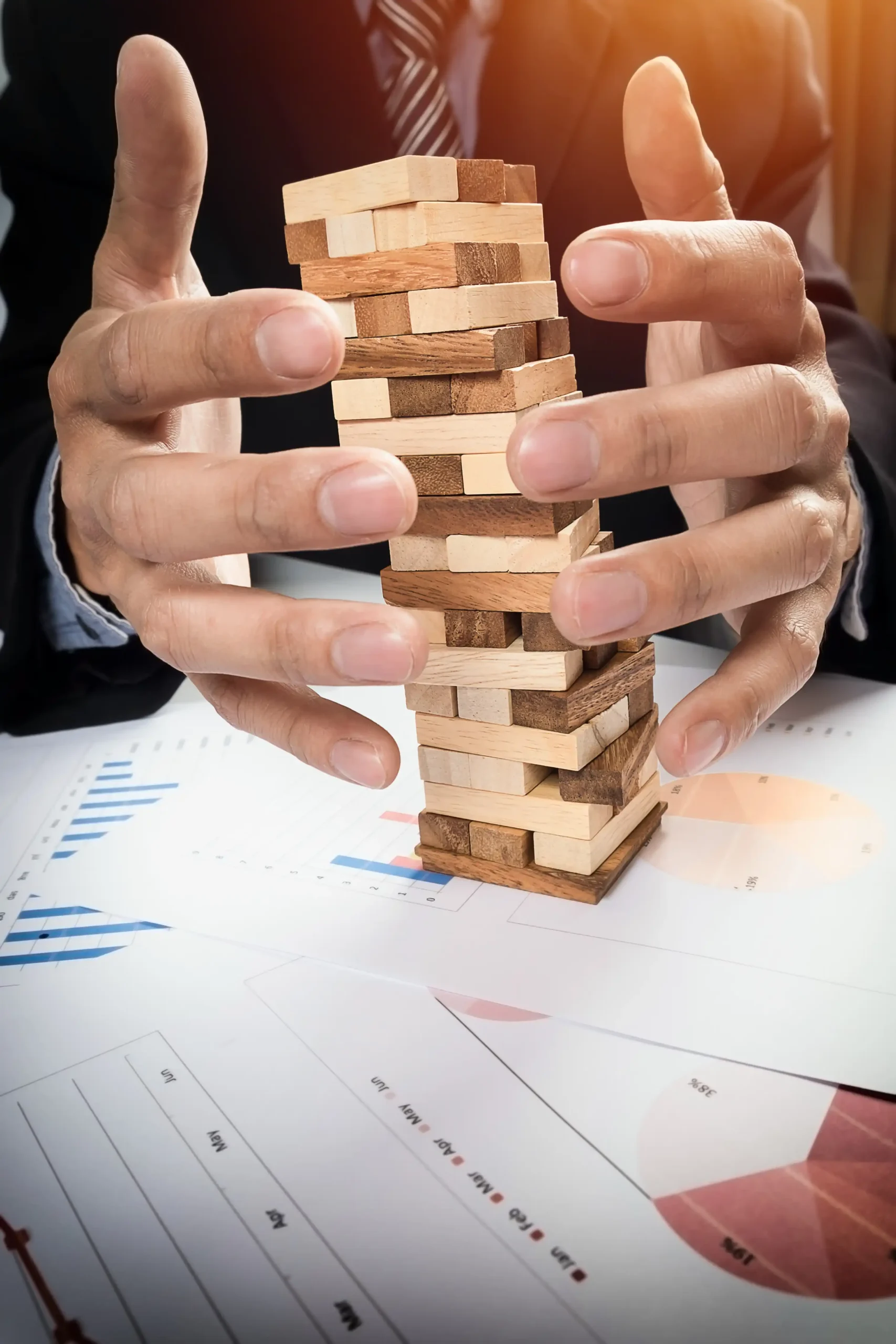 Planning risk strategy business concept businessman gambling placing wooden block tower
